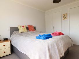 A bedroom with a bed and towels at Tregoning in Lostwithiel