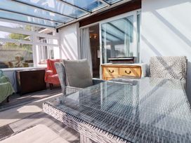 A conservatory with a glass roof and furniture at Tregoning in Lostwithiel