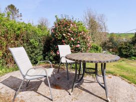 A garden area with a table and chairs at Tregoning in Lostwithiel