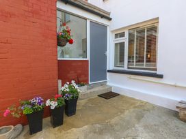 An outdoor area featuring a door, window, and planters at Tipsy Turtle in Weymouth