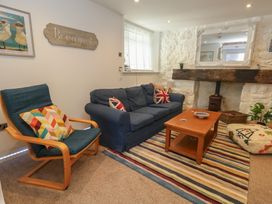 A living room with a sofa and coffee table at Tipsy Turtle in Weymouth