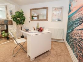 A dining room with a table and chair at Tipsy Turtle in Weymouth