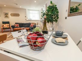 A dining table with a fruit basket and dishes at Tipsy Turtle in Weymouth