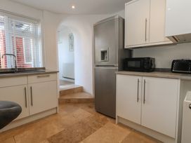 A kitchen with appliances and cabinets at Tipsy Turtle in Weymouth