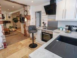 A kitchen with modern appliances and a seating area at Tipsy Turtle in Weymouth