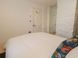 A bedroom with a bed and decorative pillow at Tipsy Turtle in Weymouth