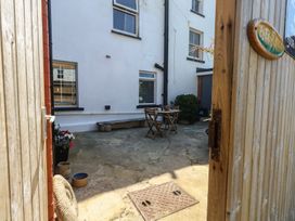 An outdoor patio with a table and chairs at Tipsy Turtle in Weymouth