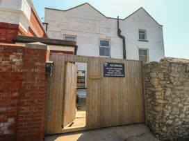 An entrance with a gate and sign at the Royal Standard Inn in Weymouth