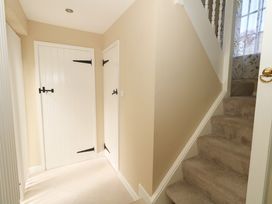 A hallway with two doors and stairs at Rose Cottage in Osmington