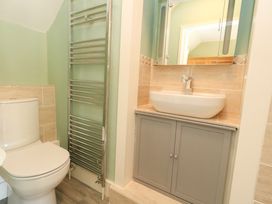 A bathroom with a toilet and sink at Rose Cottage in Osmington