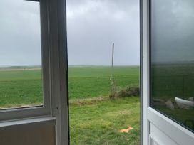 A view from a window showing grass and a fence at Watersmeet - 85 @ Park Avenue Holiday Village Leysdown-On-Sea, Kent