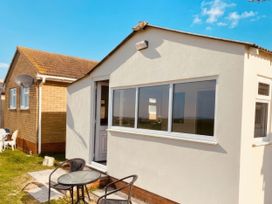 An outdoor area with a table and chairs at Watersmeet - 85 @ Park Avenue Holiday Village Leysdown-On-Sea, Kent