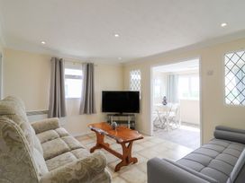 A living room with a sofa and television at Watersmeet - 85 @ Park Avenue Holiday Village, Leysdown-On-Sea, Kent