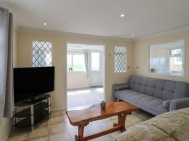 A living room with a television, sofa, and a table at Watersmeet - 85 @ Park Avenue Holiday Village, Leysdown-On-Sea, Kent