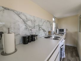 A kitchen with appliances and countertop features at Watersmeet - 85 @ Park Avenue Holiday Village, Leysdown-On-Sea, Kent