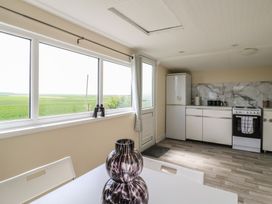 A kitchen with a refrigerator and stove at Watersmeet - 85 @ Park Avenue Holiday Village, Leysdown-On-Sea, Kent
