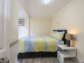 A bedroom with a bed and nightstand at Watersmeet - 85 @ Park Avenue Holiday Village, Leysdown-On-Sea, Kent