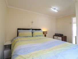 A bedroom with a bed and a dresser at Watersmeet - 85 @ Park Avenue Holiday Village, Leysdown-On-Sea, Kent