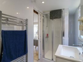 A bathroom with a shower and sink at Watersmeet - 85 @ Park Avenue Holiday Village, Leysdown-On-Sea, Kent