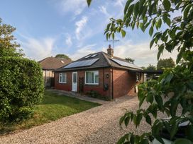 A house with solar panels and a gravel driveway at 2 North Road Maiden Newton, Dorset