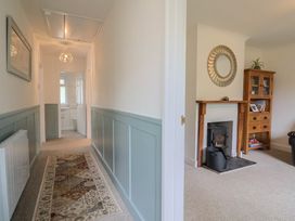 A hallway with a mirror and fireplace at 2 North Road, Maiden Newton, Dorset