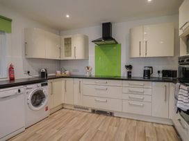 A kitchen with appliances and storage cabinets at 2 North Road Maiden Newton, Dorset
