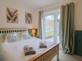 A bedroom with a bed and window at 2 North Road Maiden Newton, Dorset