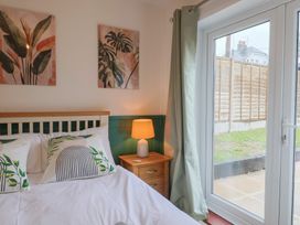 A bedroom with a bed and a window at 2 North Road in Maiden Newton, Dorset