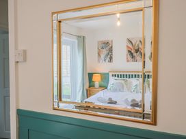 A bedroom with a bed and mirror at 2 North Road in Maiden Newton, Dorset