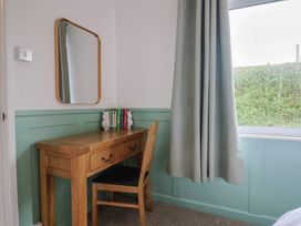 A bedroom with a desk and chair at 2 North Road in Maiden Newton, Dorset