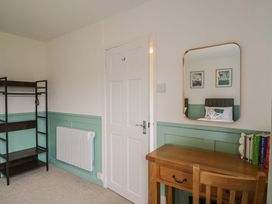 A bedroom with a desk and shelves at 2 North Road, Maiden Newton, Dorset