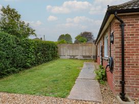 A garden with grass and a pathway at 2 North Road, Maiden Newton, Dorset