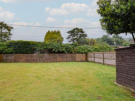 A garden with grass and a fence at 2 North Road Maiden Newton, Dorset