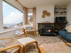 A living room with a fireplace and sofa at Wootton Gray in Penzance