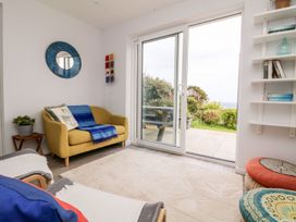 A living room with a sofa and sliding door at Wootton Gray Penzance