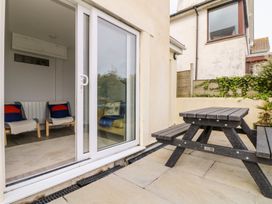 A patio area with a table and chairs at Wootton Gray in Penzance