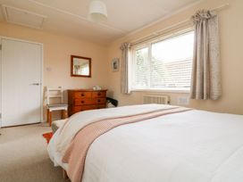 A bedroom with a bed and dresser at Wootton Gray in Penzance