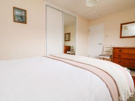 A bedroom with a bed and furniture at Wootton Gray in Penzance