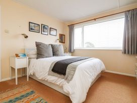 A bedroom with a bed and bedside table at Wootton Gray in Penzance