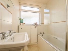 A bathroom with a bathtub and sink at Wootton Gray in Penzance