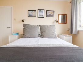 A bedroom with a bed and bedside tables at Wootton Gray in Penzance