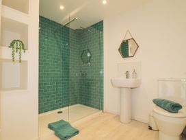 A bathroom with a shower, toilet, and sink at Wootton Gray in Penzance