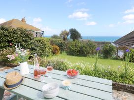 A garden table with drinks and snacks at Wootton Gray in Penzance