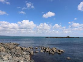 A coastal scene with water rocks and island at Wootton Gray in Penzance