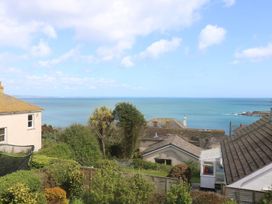 A view of the sea and houses in the foreground at Wootton Gray in Penzance