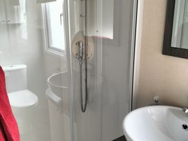 A bathroom with a shower and toilet at Beverley Bay Holiday Park - Holiday Accommodation 333 Paignton