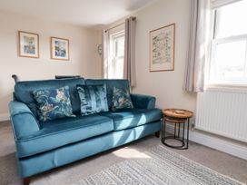 A living room with a sofa and side table at Rails End
