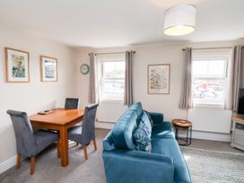 A living room with a dining table and sofa at Rails End