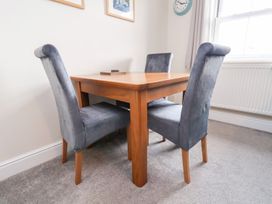 A dining table with chairs in a room at Rails End 