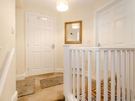 A hallway with a mirror and doors at Rails End